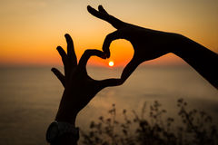 silhouette-hand-heart-shape-sunset-background-40155081